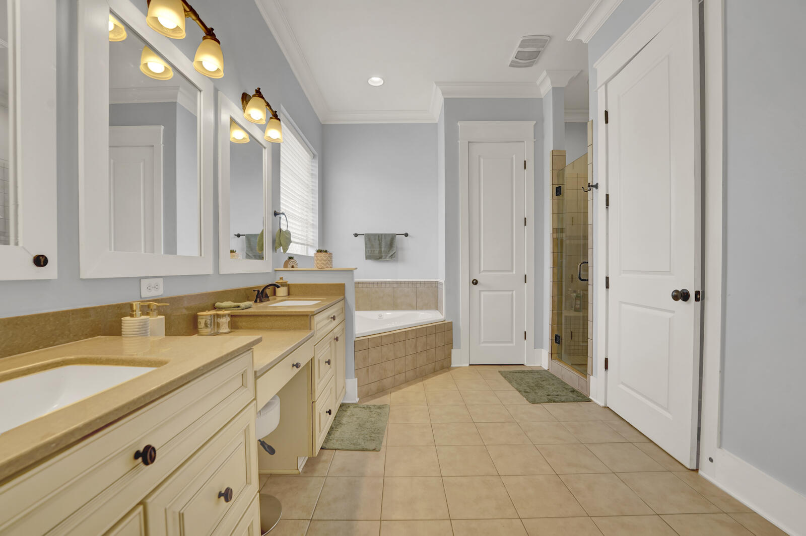 738 Symphony Way Freeport, FL 32439 - Photo 26 of 69 a spacious bathroom with a granite countertop sink mirror and a bathtub