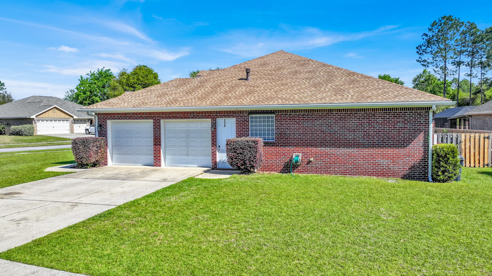 738 Symphony Way Freeport, FL 32439 - Photo 3 of 69 a front view of a house with a yard and garage