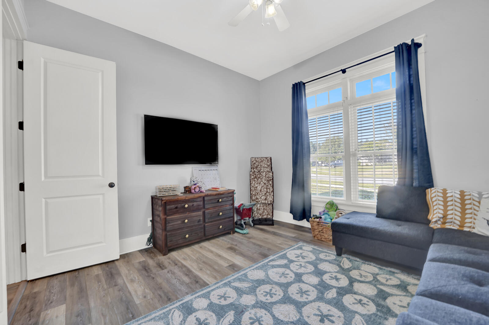 738 Symphony Way Freeport, FL 32439 - Photo 33 of 69 a living room with furniture and a flat screen tv