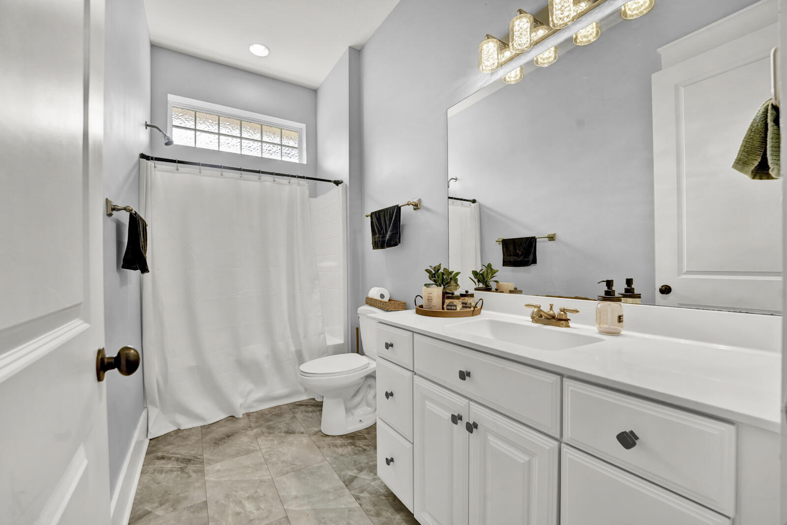 738 Symphony Way Freeport, FL 32439 - Photo 35 of 69 a spacious bathroom with a toilet sink and mirror