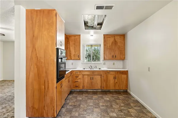 a kitchen with a sink and cabinets