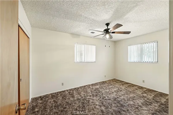 a view of a livingroom with a ceiling fan and window