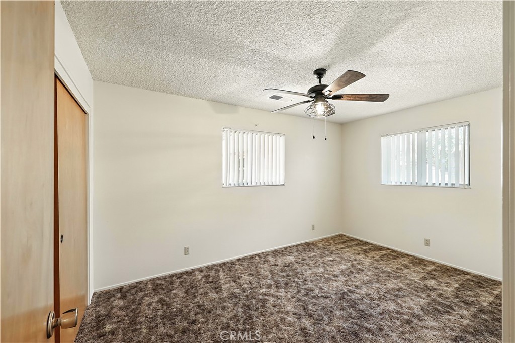 6345 Merced Falls Road Snelling, CA 95369 - Photo 15 of 54 a view of a bedroom with a ceiling fan and a window