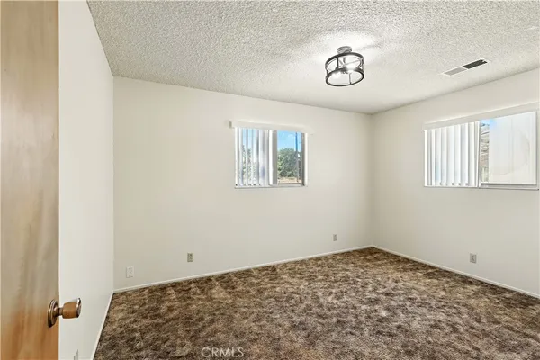 a view of a livingroom with wooden floor and a window