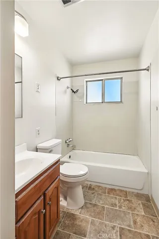 a bathroom with a toilet a sink and shower