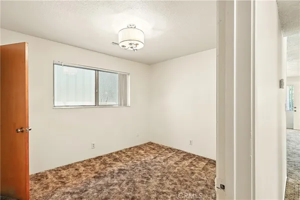 a view of room with window and wooden floor