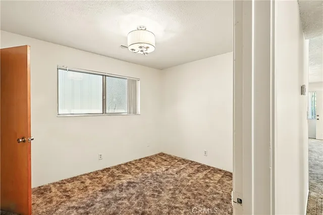 a view of room with window and wooden floor
