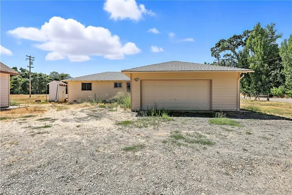 a backyard of a house with table and chairs