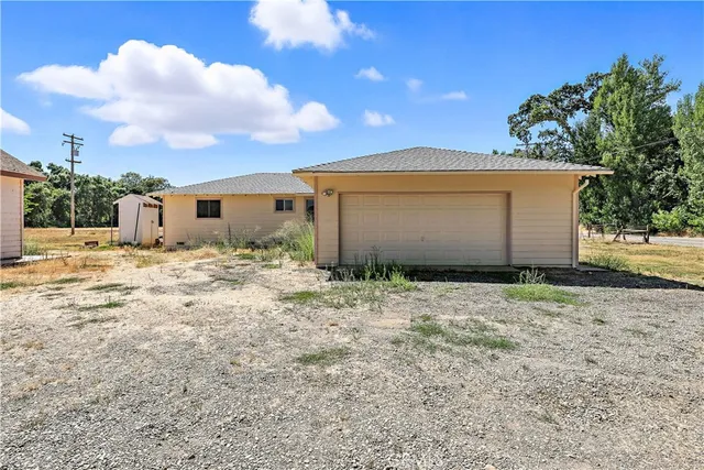 a backyard of a house with table and chairs