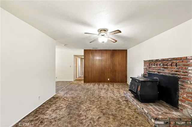 an empty room with windows and cabinet