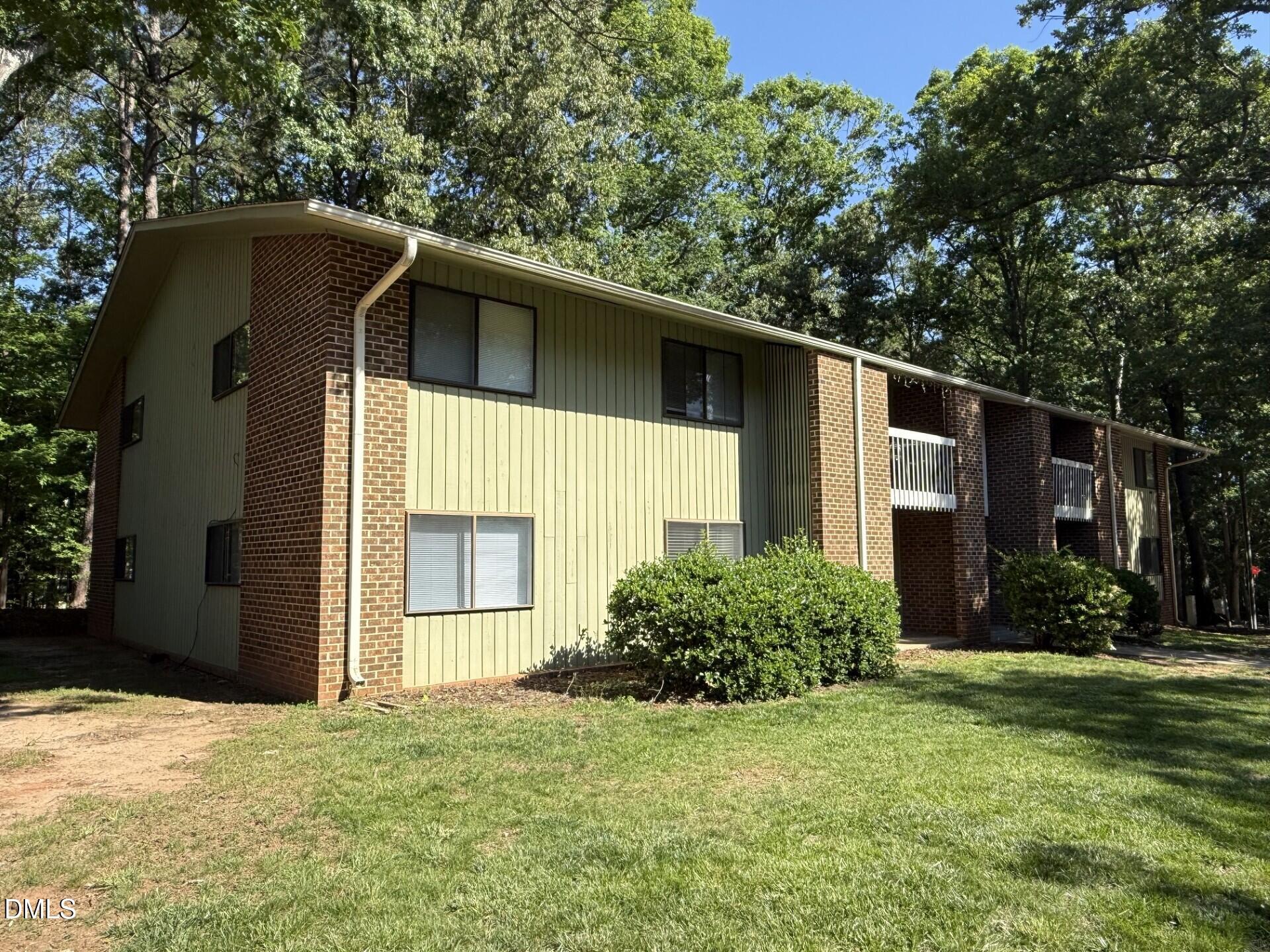 1299 Schaub Drive, Unit D Raleigh, NC 27606 - Photo 16 of 16 a house with trees in front of it