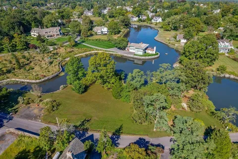 an aerial view of a house with a yard swimming pool and outdoor seating
