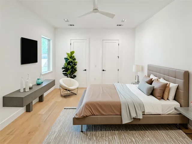 a bedroom with a bed and a flat screen tv
