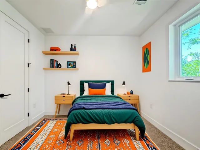 a bedroom with bed and wooden floor