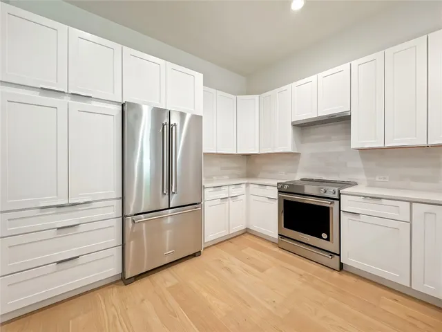 a kitchen with granite countertop stainless steel appliances and cabinets