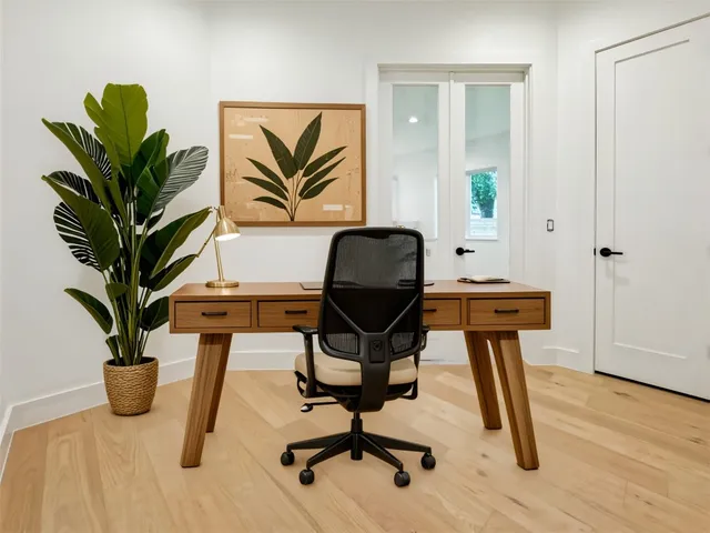 a view of a workspace with furniture and a potted plant