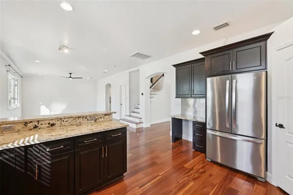 a kitchen with a refrigerator and a sink
