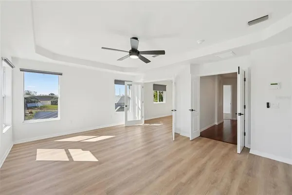 a view of empty room with wooden floor and window