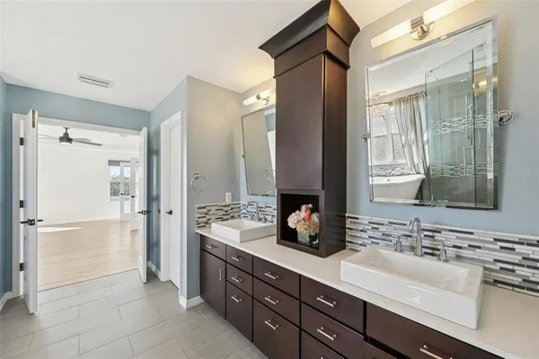 a bathroom with a double vanity sink mirror and double