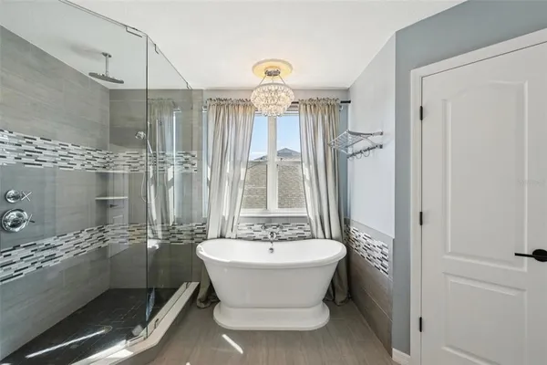 a bathroom with a tub sink and mirror