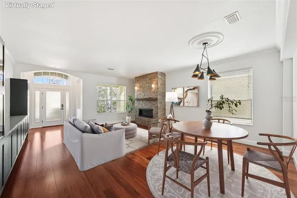 a living room with furniture dining table and a fireplace