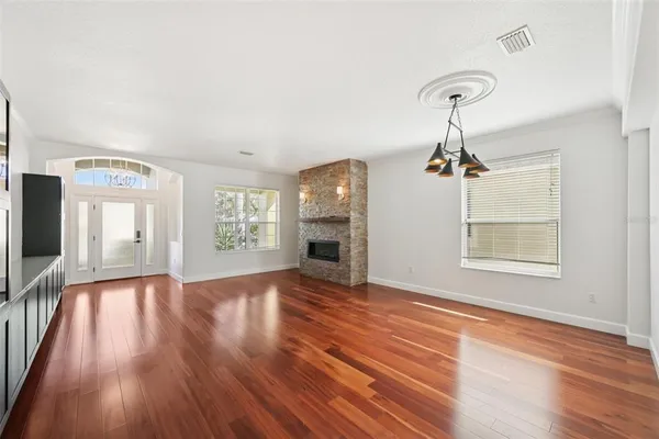 wooden floor in an empty room with a window