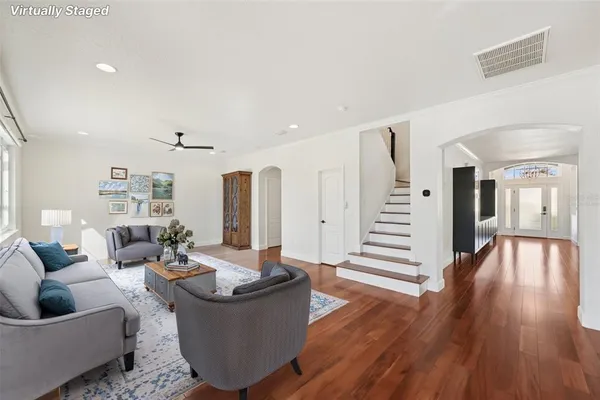 a living room with furniture and wooden floor