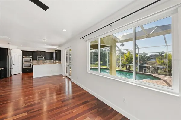a view of kitchen with a sink and refrigerator