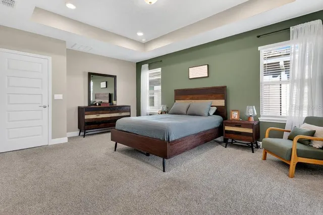 a bedroom with a bed and a dresser in it