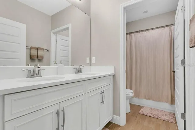 an aerial view of residential houses with outdoor space and river