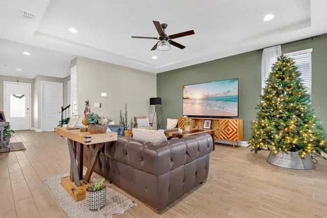 a view of a workspace with furniture window and wooden floor
