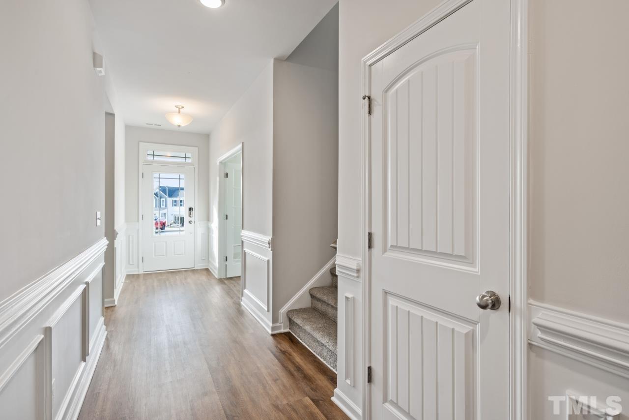 201 Karlov Road Garner, NC 27529 - Photo 3 of 39 a view of a hallway with wooden floor and staircase