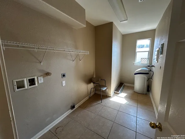 a view of a storage & utility room with a sink