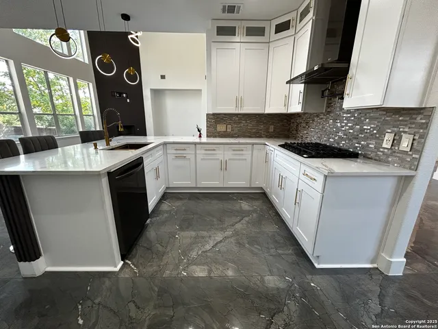 a kitchen with a sink cabinets and window
