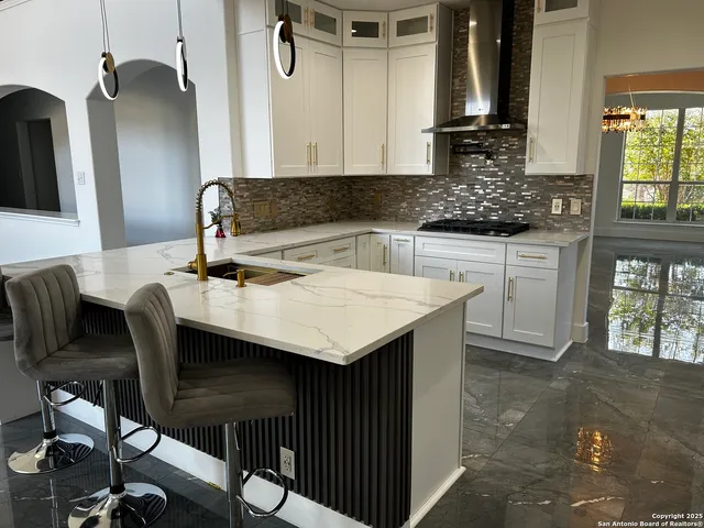 a kitchen with a table chairs sink and cabinets
