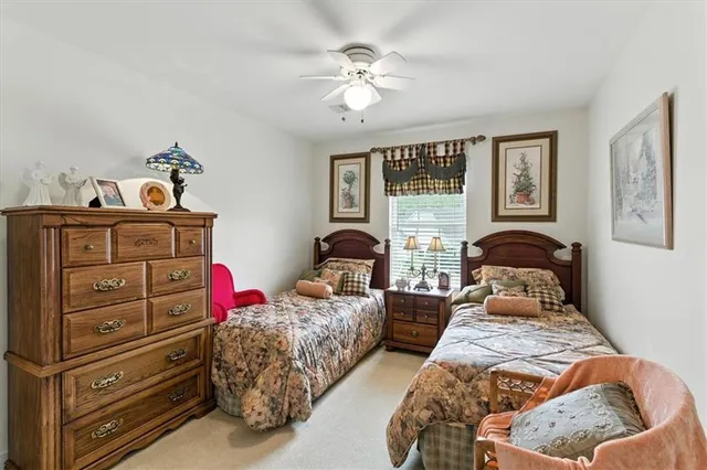 a bedroom with two beds and painting on the wall