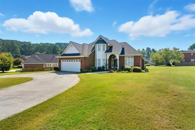 a front view of a house with a yard