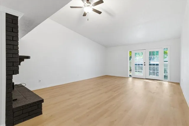 wooden floor in an empty room with a window