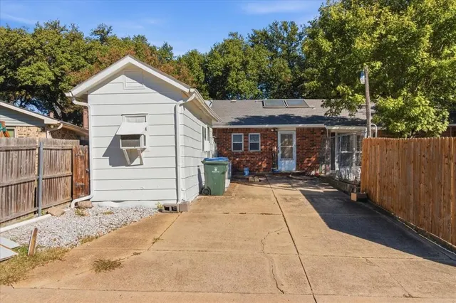 a view of house with backyard and sitting area
