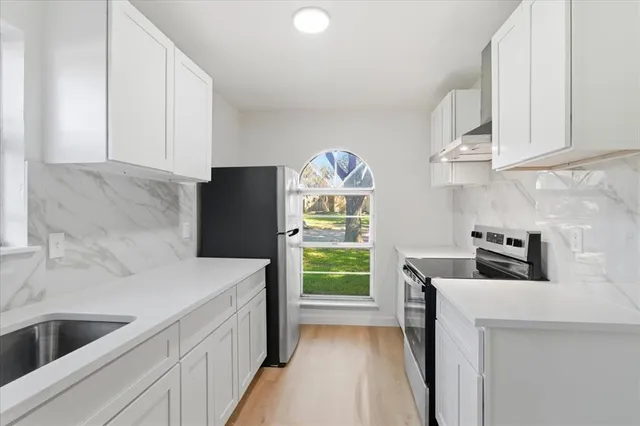 a kitchen with a refrigerator and a sink