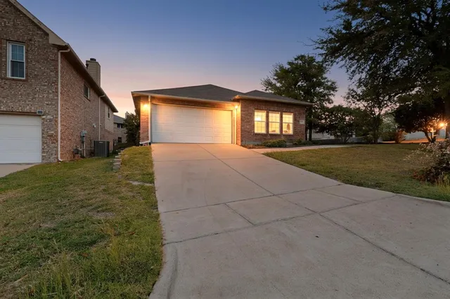 a view of a house with a yard and garage