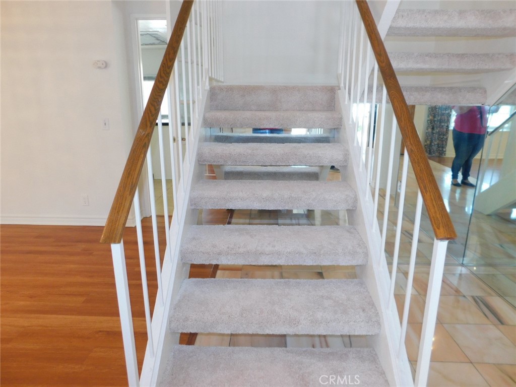 2618 Athena Place Fullerton, CA 92833 - Photo 18 of 27 a view of staircase with white walls and a window