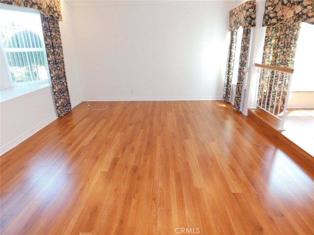 2618 Athena Place Fullerton, CA 92833 - Photo 4 of 27 a view of empty room with wooden floor and fan