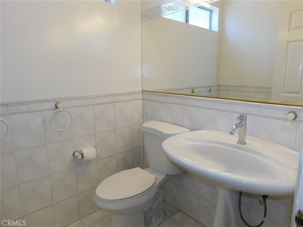 2618 Athena Place Fullerton, CA 92833 - Photo 8 of 27 a bathroom with a sink a toilet and a mirror