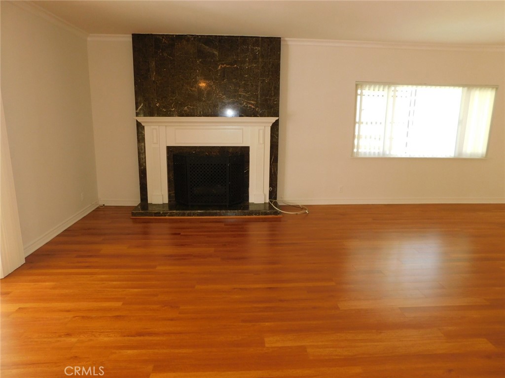 2618 Athena Place Fullerton, CA 92833 - Photo 10 of 27 a view of an empty room with wooden floor and a fireplace