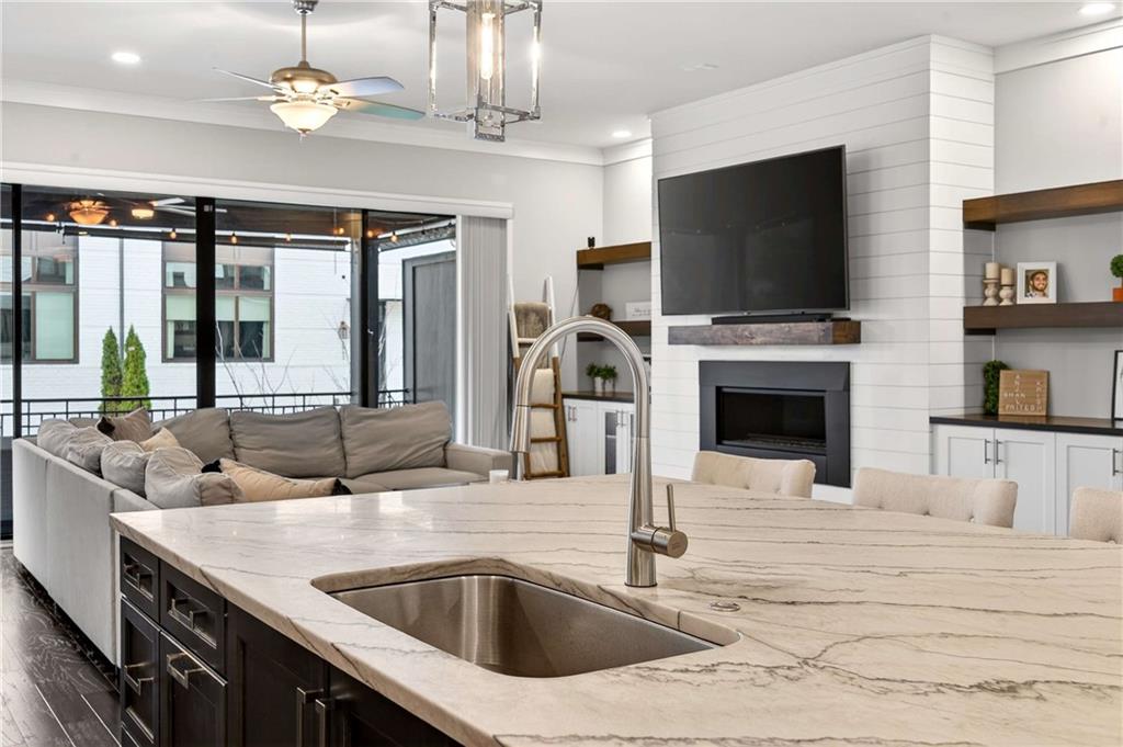 2974 Hermance Drive Northeast Atlanta, GA 30319 - Photo 11 of 38 a kitchen with a stove a sink and a flat screen tv