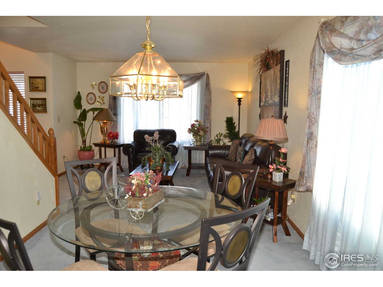 1321 Trail Ridge Road Longmont, CO 80504 - Photo 14 of 25 a dining room with furniture a chandelier and wooden floor