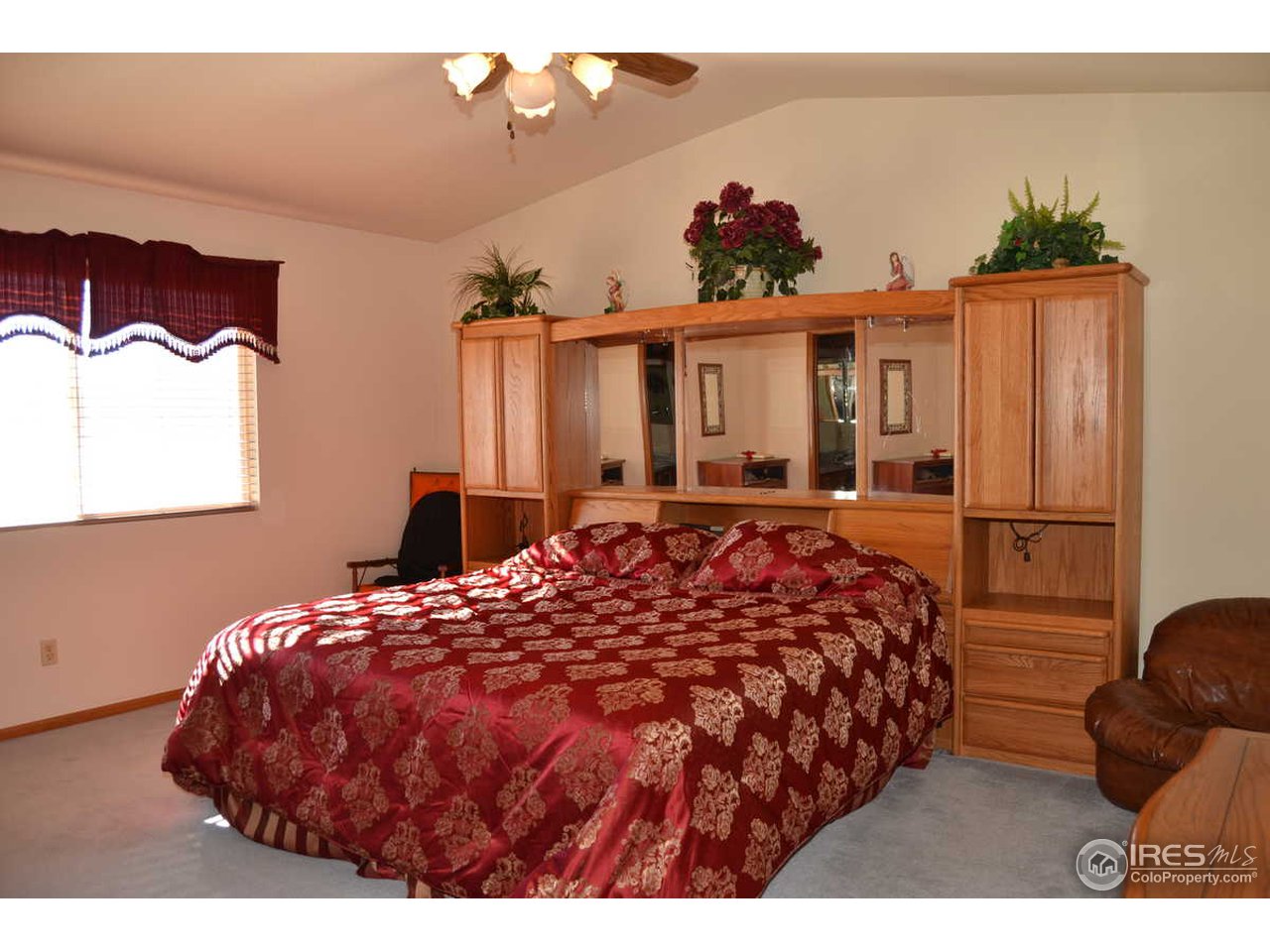 1321 Trail Ridge Road Longmont, CO 80504 - Photo 16 of 25 a bed sitting in a bedroom next to a window