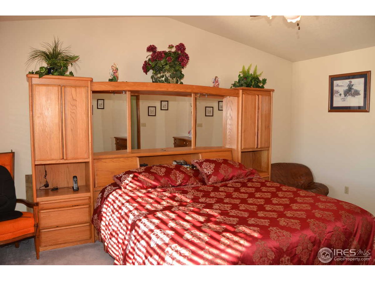 1321 Trail Ridge Road Longmont, CO 80504 - Photo 17 of 25 a bedroom with a large bed and a dresser