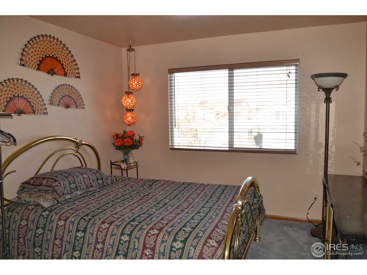 1321 Trail Ridge Road Longmont, CO 80504 - Photo 20 of 25 a bedroom with a bed and a window